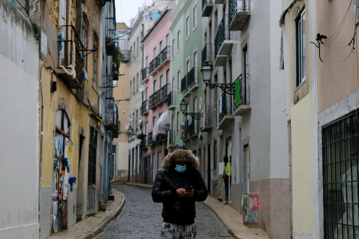 FILE PHOTO: A person wearing a protective mask walks in Bairro Alto neighborhood during the national lockdown, amid the coronavirus disease (COVID-19) pandemic, in Lisbon, Portugal, January 23, 2021. REUTERS/Pedro Nunes/File Photo
