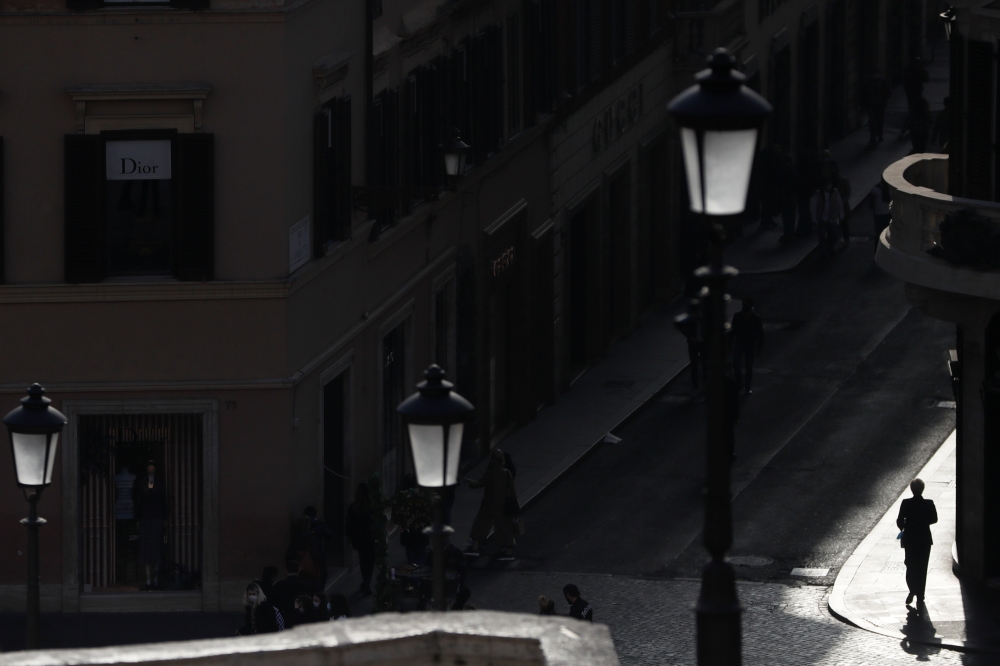 A person walks along Via dei Condotti amid the coronavirus disease (COVID-19) outbreak in Rome, Italy, February 26, 2021. REUTERS/Yara Nardi