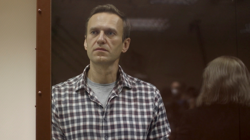 File photo of Kremlin critic Alexei Navalny as he stands inside a defendant dock during a court hearing in Moscow, Russia, Russia February 20, 2021, in this still image taken from video. Press Service of Babushkinsky District Court of Moscow/Handout via R