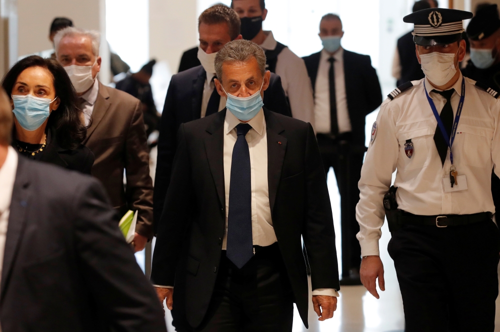 Former French President Nicolas Sarkozy, wearing a protective face mask, arrives for the verdict in his trial on charges of corruption and influence peddling, at Paris courthouse, France, March 1, 2021. REUTERS/Gonzalo Fuentes