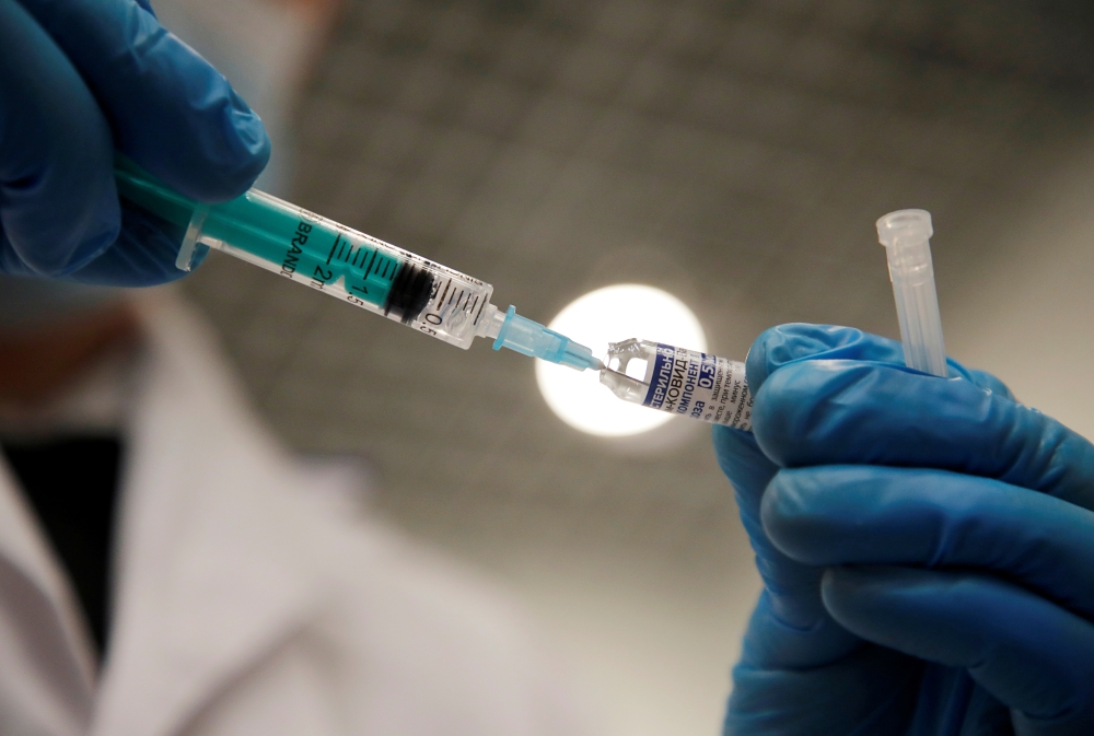 A medical worker holds a syringe with Sputnik V vaccine against the coronavirus disease (COVID-19) at a vaccination centre in Saint Petersburg, Russia February 24, 2021. REUTERS/Anton Vaganov/File Photo