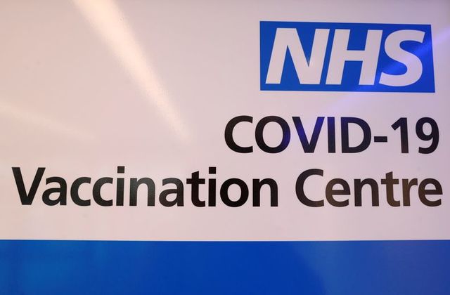 FILE PHOTO: An NHS sign is displayed at the coronavirus disease (COVID-19) vaccination centre at Cliffs Pavilion in Southend-on-Sea, Britain, February 4, 2021. REUTERS/Paul Childs
