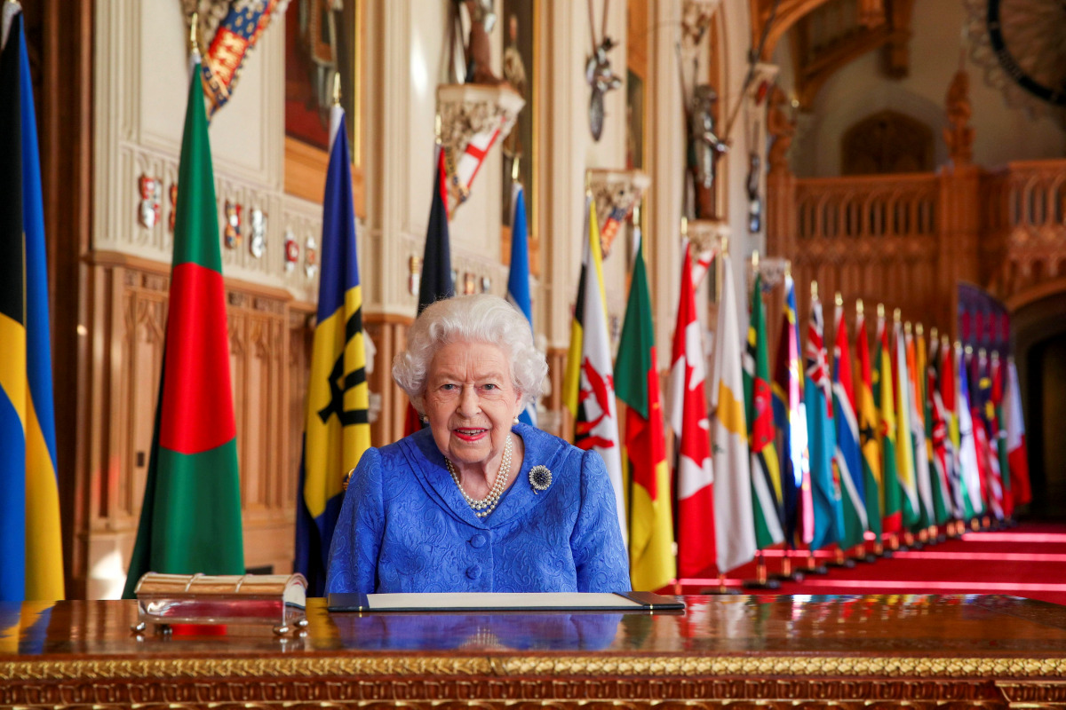 Britain's Queen Elizabeth II signs her annual commonwealth Day message in St George's Hall at Windsor Castle, Britain, in this picture issued March 5, 2021. Steve Parsons/Pool via REUTERS
