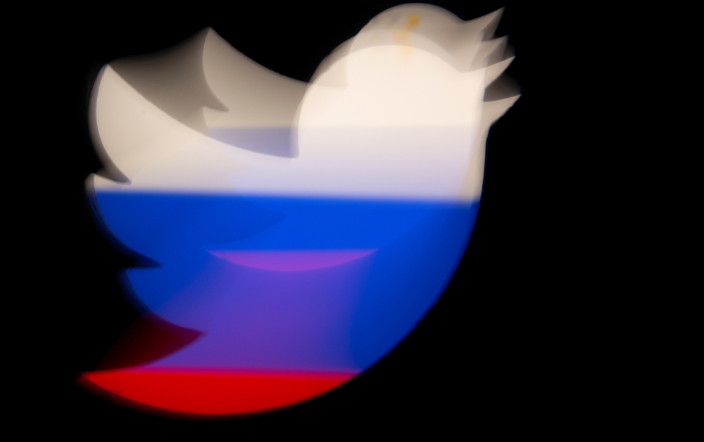 A 3d printed Twitter logo is pictured in front of a displayed Russian flag in this illustration taken March 10, 2021. Reuters/Dado Ruvic/Illustration