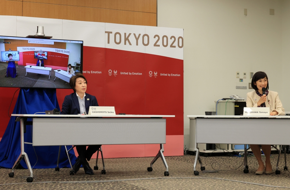 Japanese Olympic Minister Tamayo Marukawa (R) delivers a speech while Tokyo 2020 Organizing Committee president Seiko Hashimoto (L) listens to at a five-party meeting of Tokyo 2020 Olympic and Paralympic Games with International Paralympic Committee (IPC)