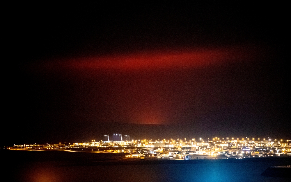 A volcanic eruption is seen (rear) near Fagradalsfjall, a mountain on the Reykjanes Peninsula, Iceland March 19, 2021, in this picture obtained from social media. Picture taken March 19, 2021. Mandatory credit VF.IS/via REUTERS.