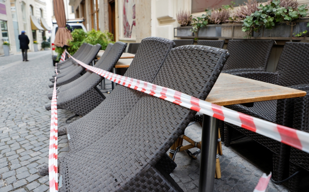 Tables and chairs are seen next to a closed restaurant as the coronavirus disease (COVID-19) lockdown continues in Vienna, Austria March 22, 2021. REUTERS/Leonhard Foeger