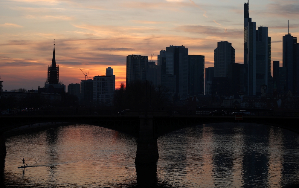 A stand-up paddler enjoys the first warm spring evening as the spread of the coronavirus disease (COVID-19) continues in Frankfurt, Germany, March 24, 2021. REUTERS/Kai Pfaffenbach