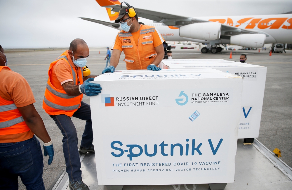 Workers take care of the shipment of Russia's Sputnik V vaccine against the coronavirus disease (COVID-19) at the airport, in Caracas, Venezuela March 29, 2021. REUTERS/Manaure Quintero