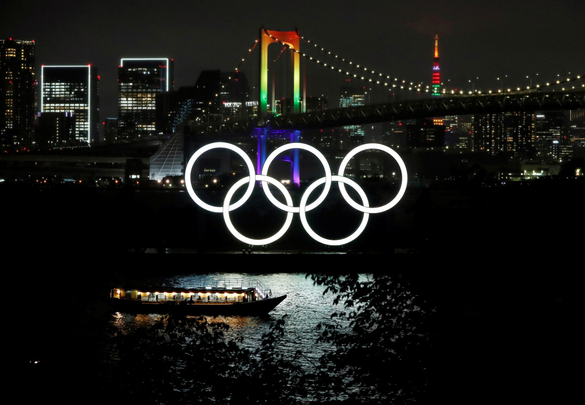 The Rainbow Bridge and Tokyo Tower are illuminated with Olympic colours to mark 100 days countdown to the Tokyo 2020 Olympics that have been postponed to 2021 due to the coronavirus disease (COVID-19) outbreak, in Tokyo, Japan April 14, 2021. REUTERS/Isse
