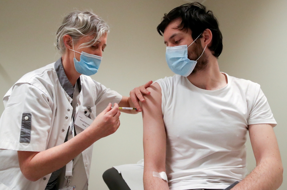 A volunteer receives a dose of CureVac vaccine or a placebo during a study by the German biotech firm CureVac as part of a testing for a new vaccine against the coronavirus disease (COVID-19), in Brussels, Belgium March 2, 2021. REUTERS/Yves Herman/File P