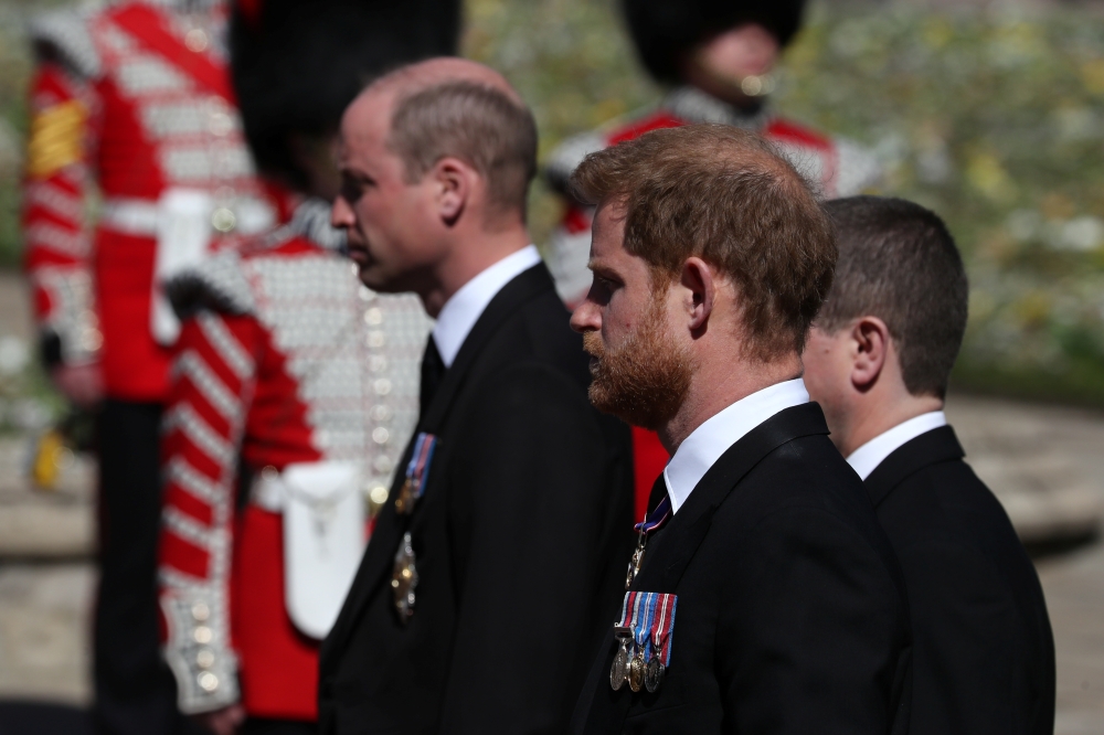 Britain's Prince Harry, Duke of Sussex and Britain's Prince William, Duke of Cambridge, look on during the funeral of Britain's Prince Philip, husband of Queen Elizabeth, who died at the age of 99, in Windsor, Britain, on April 17, 2021. (REUTERS)