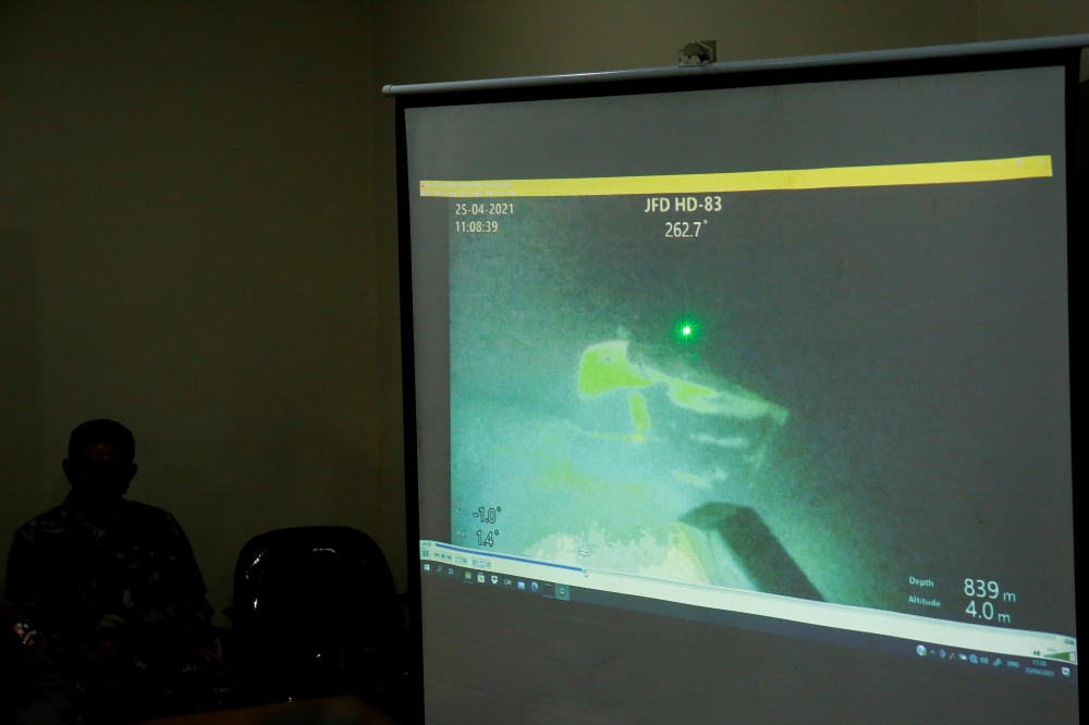 The military personnel display a video showing what is believed to be the sunken Indonesian Navy KRI Nanggala-402 submarine during a media conference at I Gusti Ngurah Rai Airport in Bali, Indonesia, April 25, 2021. Reuters/Johannes P. Christo