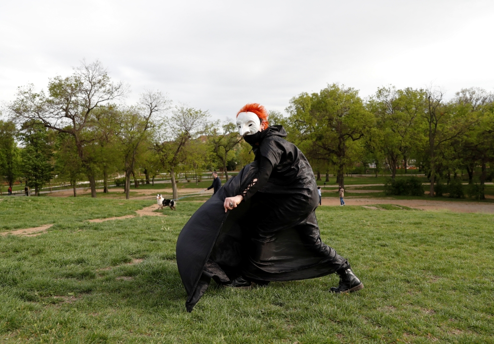 Aerial acrobat, Eszter Kovacs, performs during a performance of the Utca-SZAK street theatre group, amid the coronavirus disease (COVID-19) pandemic, in Budapest, Hungary, May 2, 2021. Picture taken May 2, 2021. Reuters/Bernadett Szabo