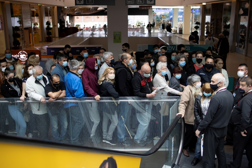 People wait to get shots of vaccines against the coronavirus disease (COVID-19) in the Usce shopping mall, where the first 100 vaccinated will receive a discount voucher worth 3,000 dinars ($30.74) secured by mall's management and retailers, in Belgrade, 