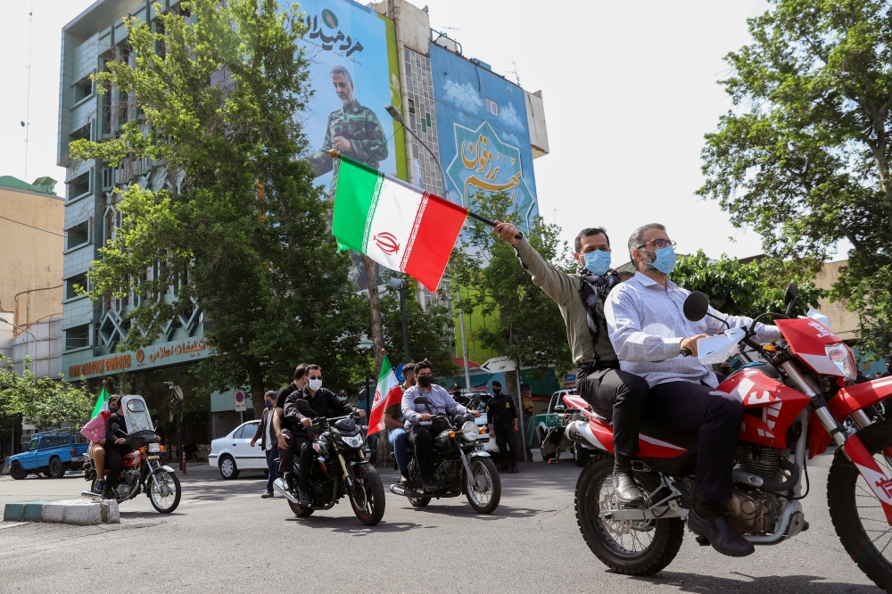 Iranians ride on motorbikes in Tehran, Iran on May 7, 2021. (Majid Asgaripour/WANA /REUTERS)
