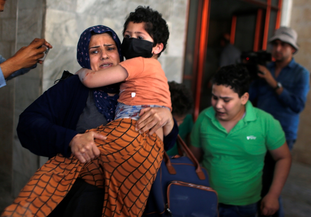 Palestinians evacuate following an Israeli airstrike on a building in Gaza City May 11, 2021. Reuters/Mohammed Salem