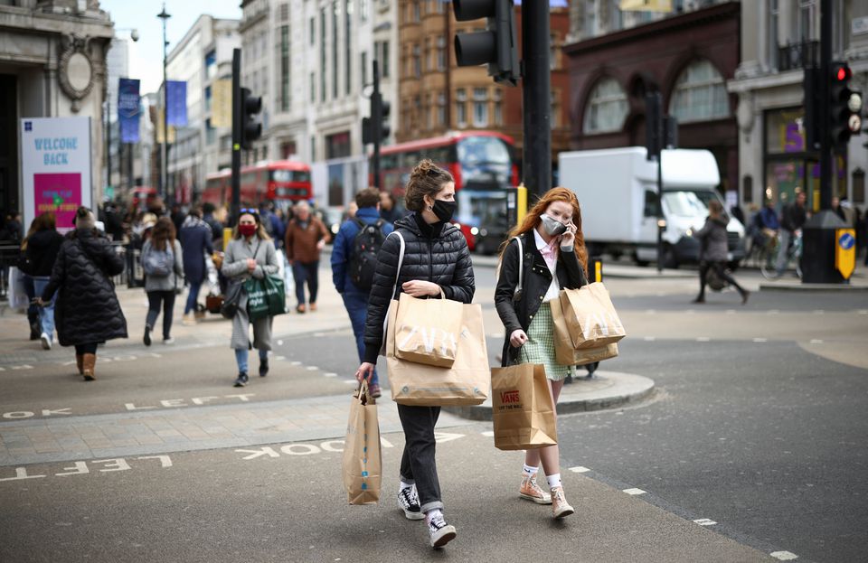 People walk at Oxford Street, as the coronavirus disease (COVID-19) restrictions ease, in London, Britain April 12, 2021. REUTERS/Henry Nicholls
