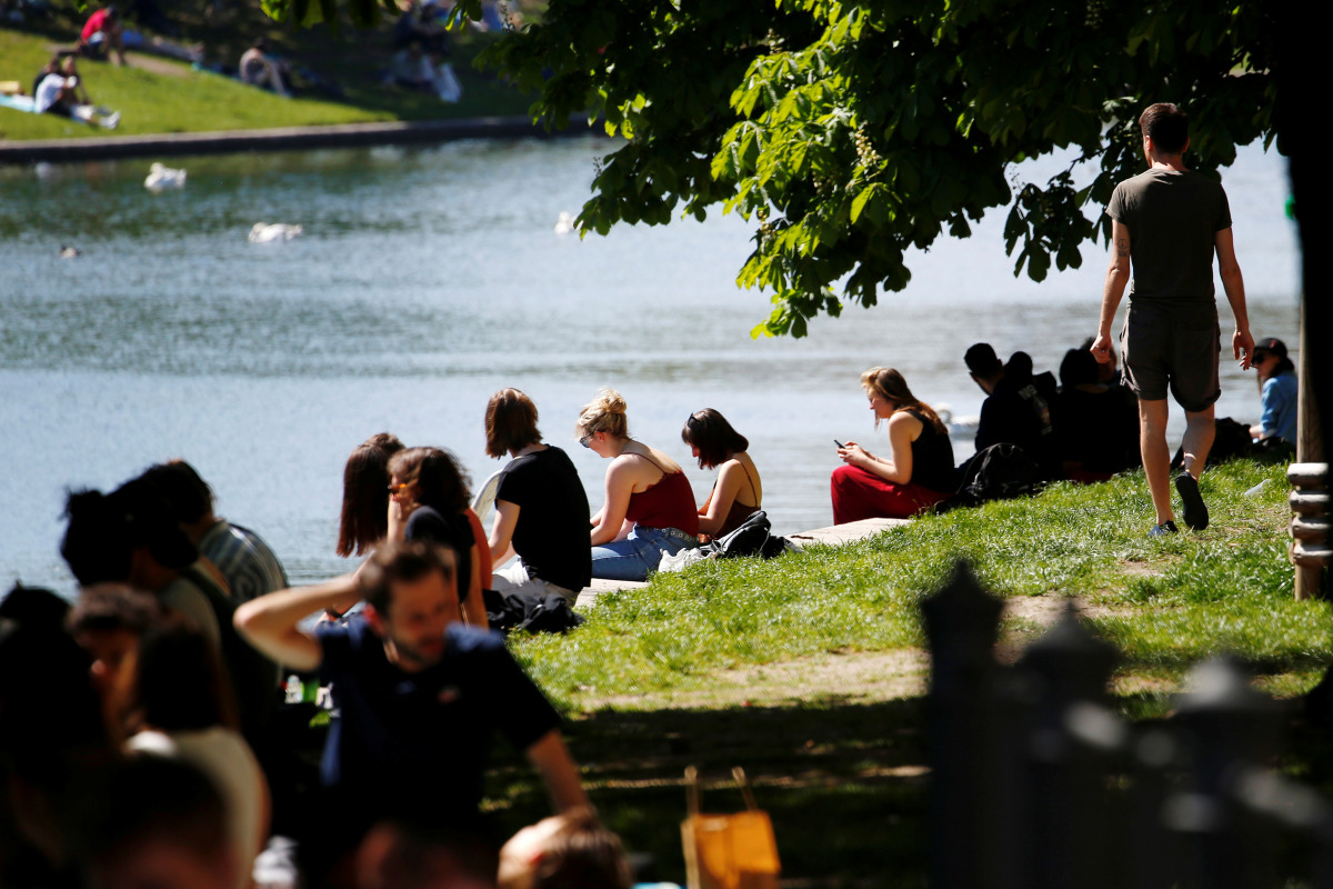 People relax at Landswehrkanal in Kreuzberg District on a sunny, warm day in Berlin, Germany, May 10, 2021. REUTERS/Michele Tantussi

