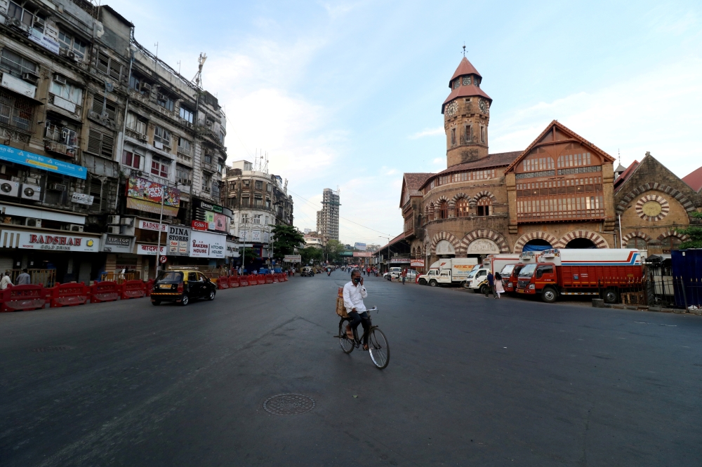 A man rides his bicycle during a lockdown to limit the spread of the coronavirus disease (COVID-19) in Mumbai, India, April 23, 2021. REUTERS/Niharika Kulkarni/File Photo