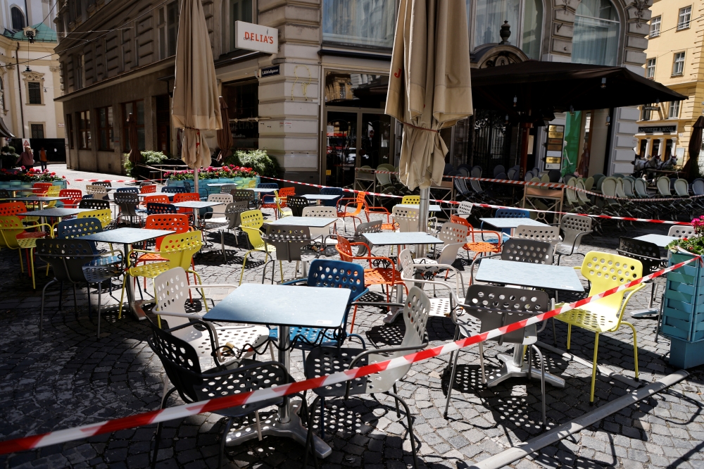 Chairs and tables line up in front of a cafe during preparations for the reopening of restaurants as part of an easing of the country's lockdown restrictions amid the coronavirus disease (COVID-19) outbreak in Vienna, Austria May 18, 2021. Reuters/Leonhar