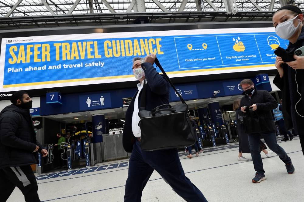 People travel through Waterloo railway station during the morning rush hour as coronavirus disease (COVID-19) restrictions continue to ease throughout the country, London, Britain, May 19, 2021. REUTERS/Toby Melville