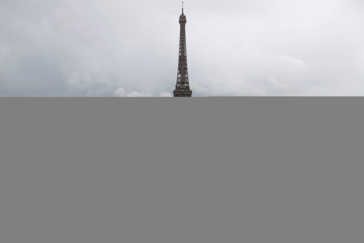 A man poses on a giant artwork by French artist JR installed on the Trocadero square in front of the Eiffel Tower in Paris, France, May 19, 2021. REUTERS/Sarah Meyssonnier NO RESALES. NO ARCHIVES TPX IMAGES OF THE DAY
