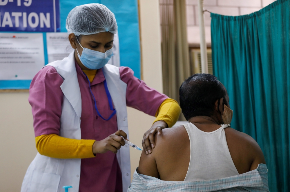 File photo: A man receives a Bharat Biotech's COVID-19 vaccine called COVAXIN, at a vaccination centre, in New Delhi, India, February 13, 2021. Reuters/Adnan Abidi/File Photo