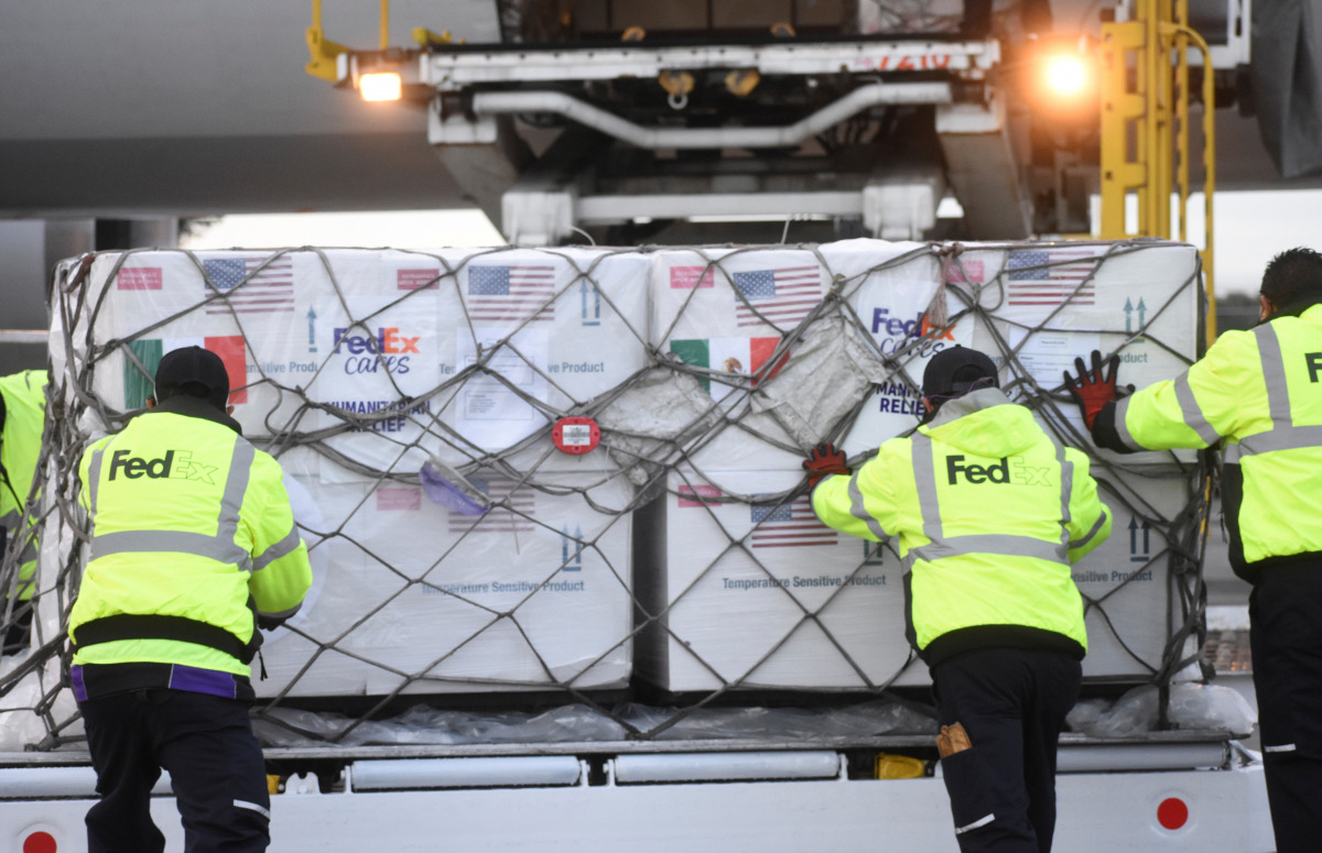 Workers manoeuvre a batch of Johnson & Johnson coronavirus disease (COVID-19) vaccines from the United States after its arrival to the Toluca International Airport, in San Pedro Totoltepec, Mexico June 15, 2021. Mexico's Presidency/Handout via REUTERS 