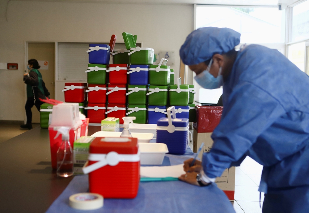 A healthcare worker takes inventory of doses of the Oxford/AstraZeneca coronavirus disease (COVID-19) vaccine, in Buenos Aires, Argentina June 4, 2021. Reuters/Matias Baglietto/File Photo