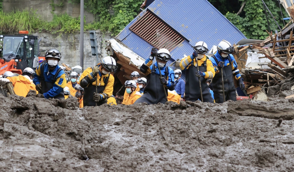 Police officers conduct a rescue and search operation at the site of a mudslide caused by heavy rain at Izusan district in Atami, Japan July 5, 2021.