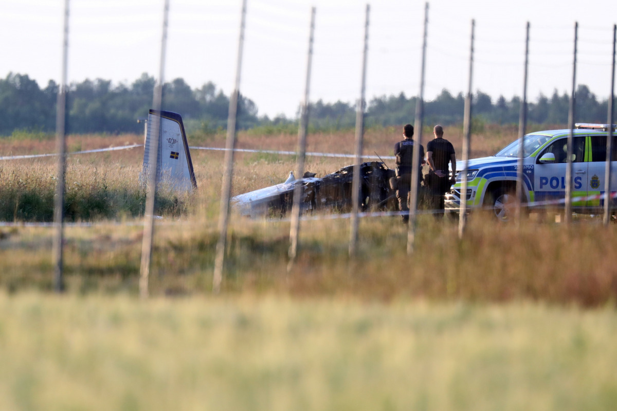 Police officers observe a small aircraft that crashed at Orebro Airport, Orebro, Sweden, July 8 2021. TT News Agency/Jeppe Gustafsson via REUTERS