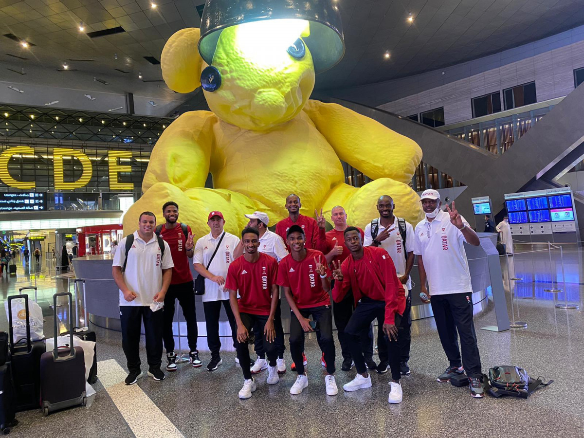 Qatari athletes and officials pose for a photograph at the Hamad International Airport
in Doha prior to their departure for Tokyo.