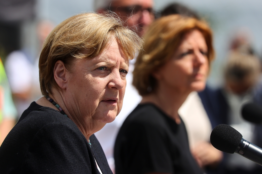 German Chancellor Angela Merkel and Rhineland-Palatinate State Premier Malu Dreyer hold a news conference in the flood-ravaged village of Schuld, near Bad Neuenahr-Ahrweiler, Rhineland-Palatinate state, Germany, July 18, 2021. REUTERS/Wolfgang Rattay