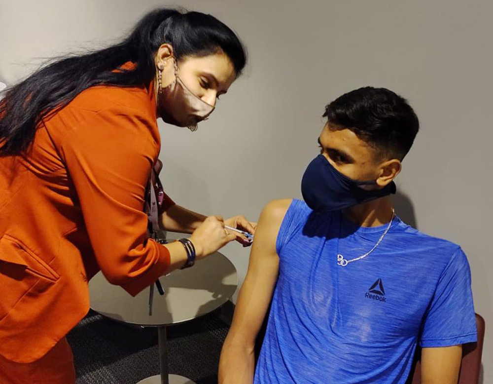 An athlete gets the COVID-19 vaccination. 
