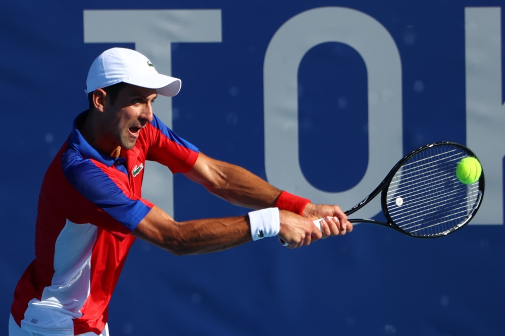 July 24, 2021. Novak Djokovic of Serbia in action during his first round match against Hugo Dellien of Bolivia REUTERS/Mike Segar
