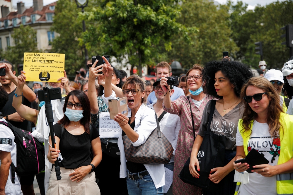 Protesters hold placards during a demonstration called by the 