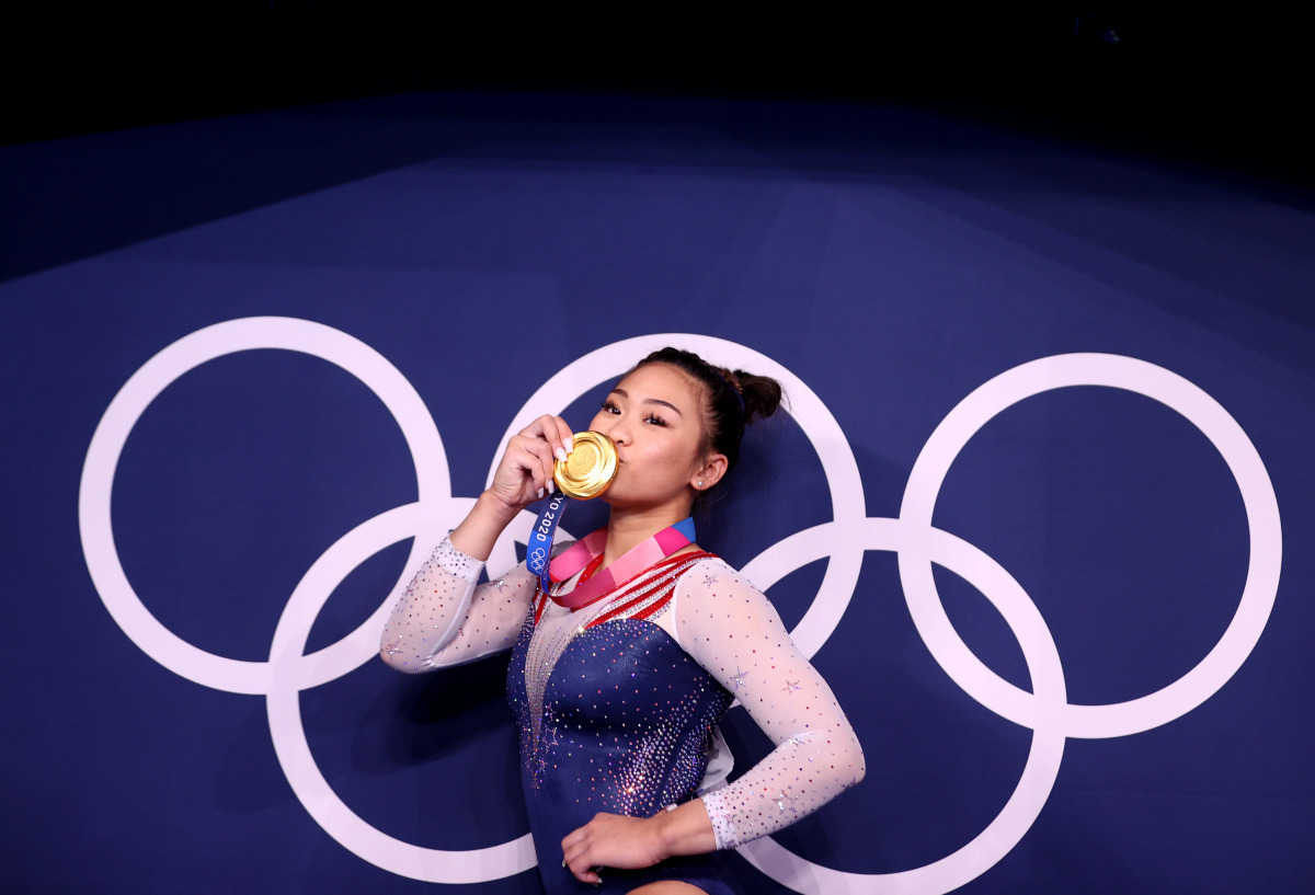 Tokyo 2020 Olympics - Gymnastics - Artistic - Women's Individual All-Around - Medal Ceremony - Ariake Gymnastics Centre, Tokyo, Japan - July 29, 2021. Gold medallist Sunisa Lee of the United States kisses her medal in front of the olympic rings REUTERS/Li