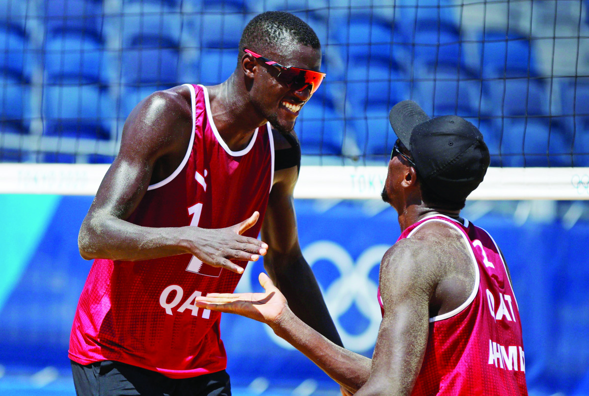 Qatar's Cherif Younousse and Ahmed Tijan celebrate their win against Lucena and Dalhausser of the US in their round of 16 match yesterday.