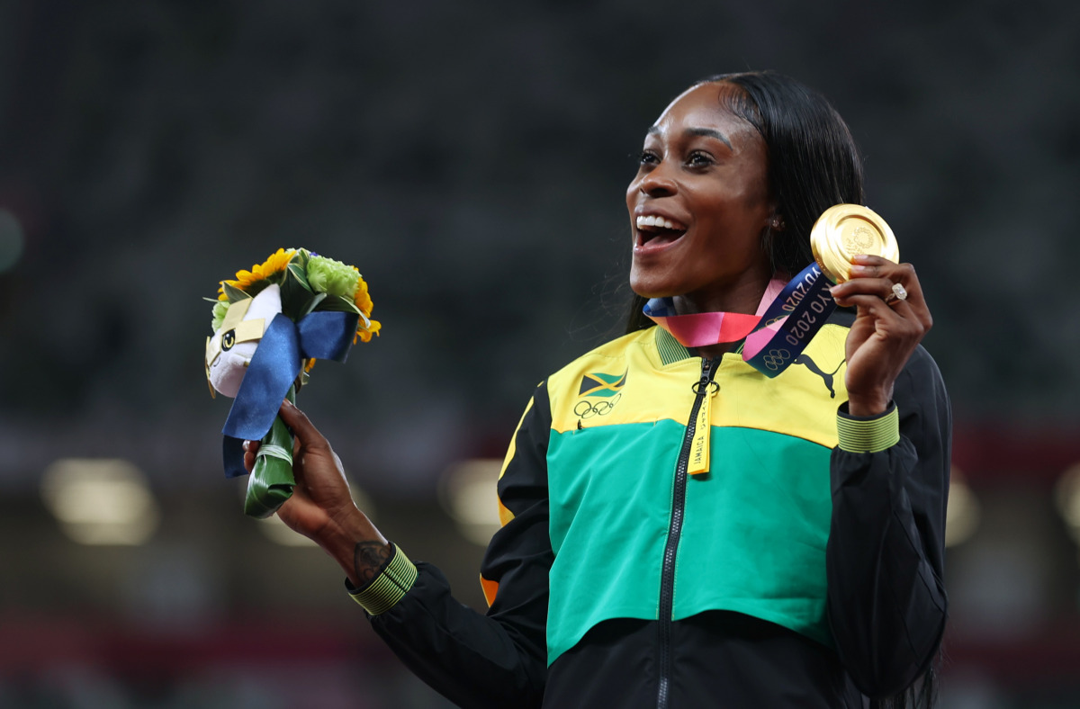 Tokyo 2020 Olympics - Athletics - Women's 200m - Medal Ceremony - Olympic Stadium, Tokyo, Japan - August 4, 2021. Gold medallist Elaine Thompson-Herah of Jamaica celebrates on the podium REUTERS/Lindsey Wasson
