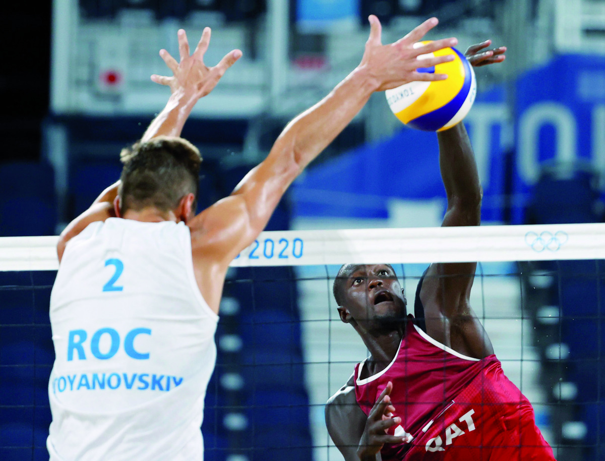 Cherif Younousse of Qatar shoots to score against the Russian Olympic Committee team as Oleg Stoyanovskiy tries to block his effort during their semi-final match played in Tokyo, yesterday.