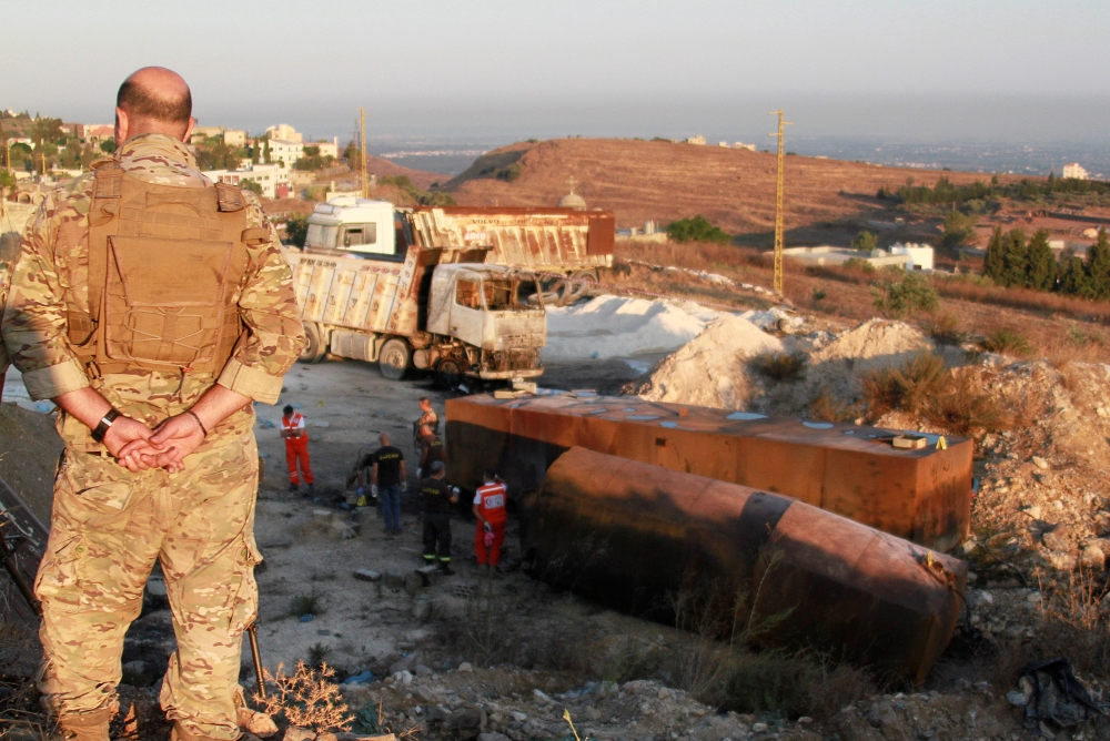 A Lebanese army soldier stands guard near the site of a fuel tank explosion in Akkar, in northern Lebanon, August 15, 2021. Reuters/Omar Ibrahim