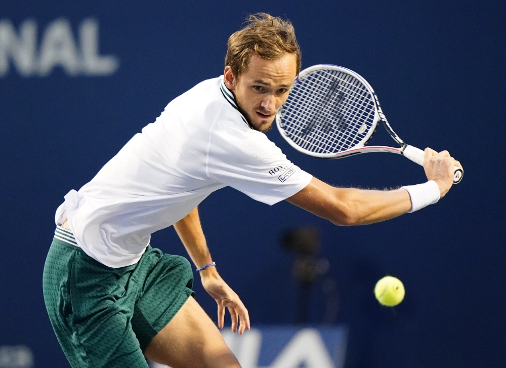 Daniil Medvedev of Russia returns a ball to John Isner of the United States (not pictured) at Aviva Centre