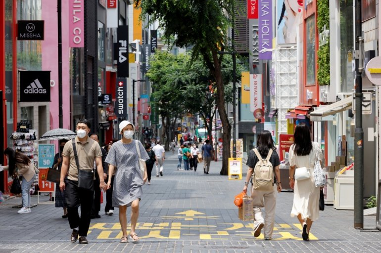 People wearing masks walk in a shopping district amid the coronavirus disease (COVID-19) pandemic in Seoul, South Korea, July 9, 2021. REUTERS/ Heo Ran/File Photo