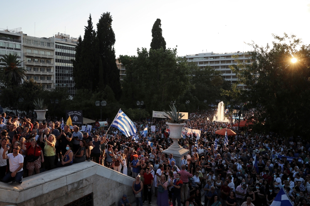 People take part in a protest against coronavirus disease (COVID-19) vaccinations outside the parliament building, in Athens, Greece, August 29, 2021. REUTERS/Costas Baltas

