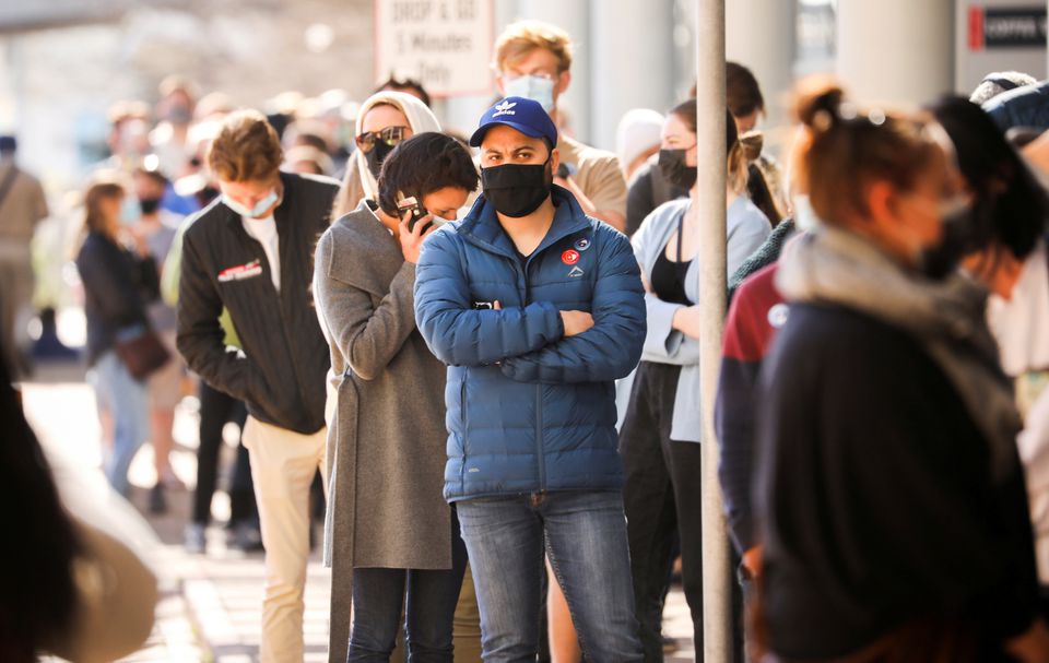 People queue outside a coronavirus disease (COVID-19) vaccination centre as the country opens vaccinations for everyone 18 years old and above in Cape Town, South Africa, August 20, 2021. REUTERS/Mike Hutchings/File Photo