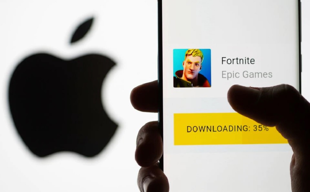 Fortnite game download on Android operating system is seen in front of Apple logo in this illustration taken, May 2, 2021. REUTERS/Dado Ruvic/Illustration
