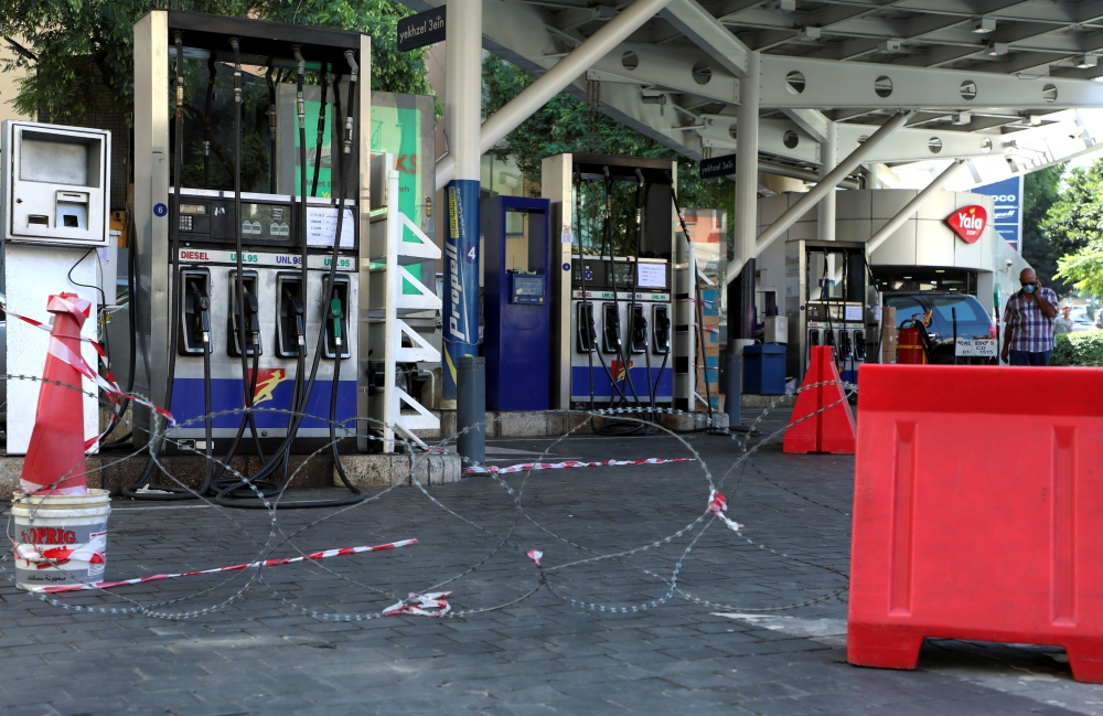 A man walks through a closed petrol station in Beirut, Lebanon September 22, 2021. REUTERS/Mohamed Azakir