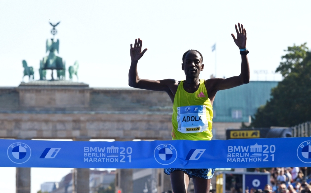 September 26, 2021 Ethiopia's Guye Adola celebrates after winning the elite men's race REUTERS/Annegret Hilse