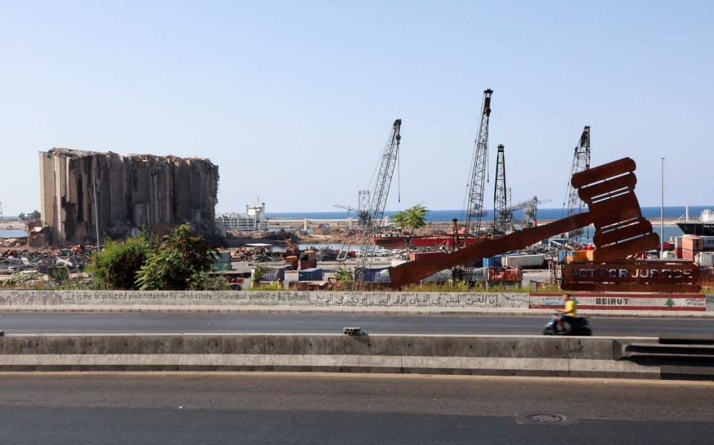 A person rides a motorbike near the site of the 2020 port blast in Beirut, Lebanon September 27, 2021. REUTERS/Mohamed Azakir